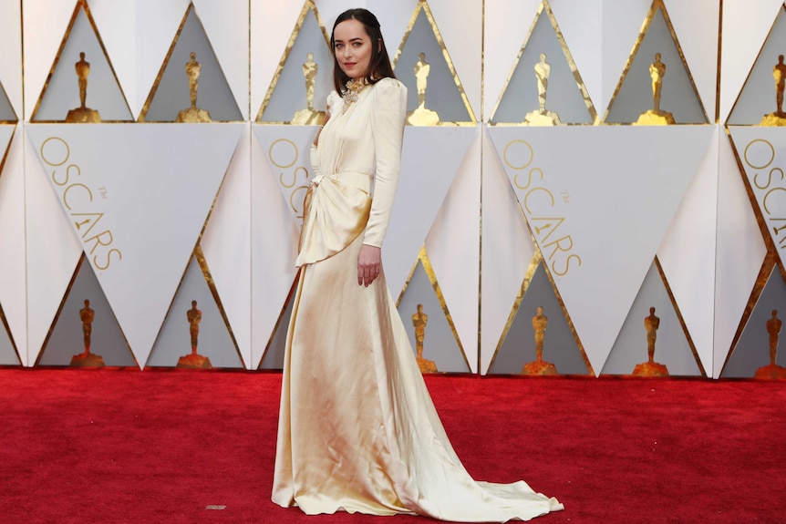 Actress Dakota Johnson arrives on the Oscars red carpet.