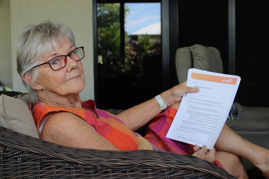 a woman aged in her 60s or 70s reading a contract