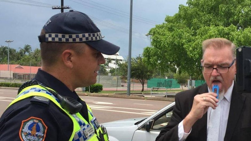 Police Minister Peter Chandler tries out one of the saliva swabs that will detect illegal drugs