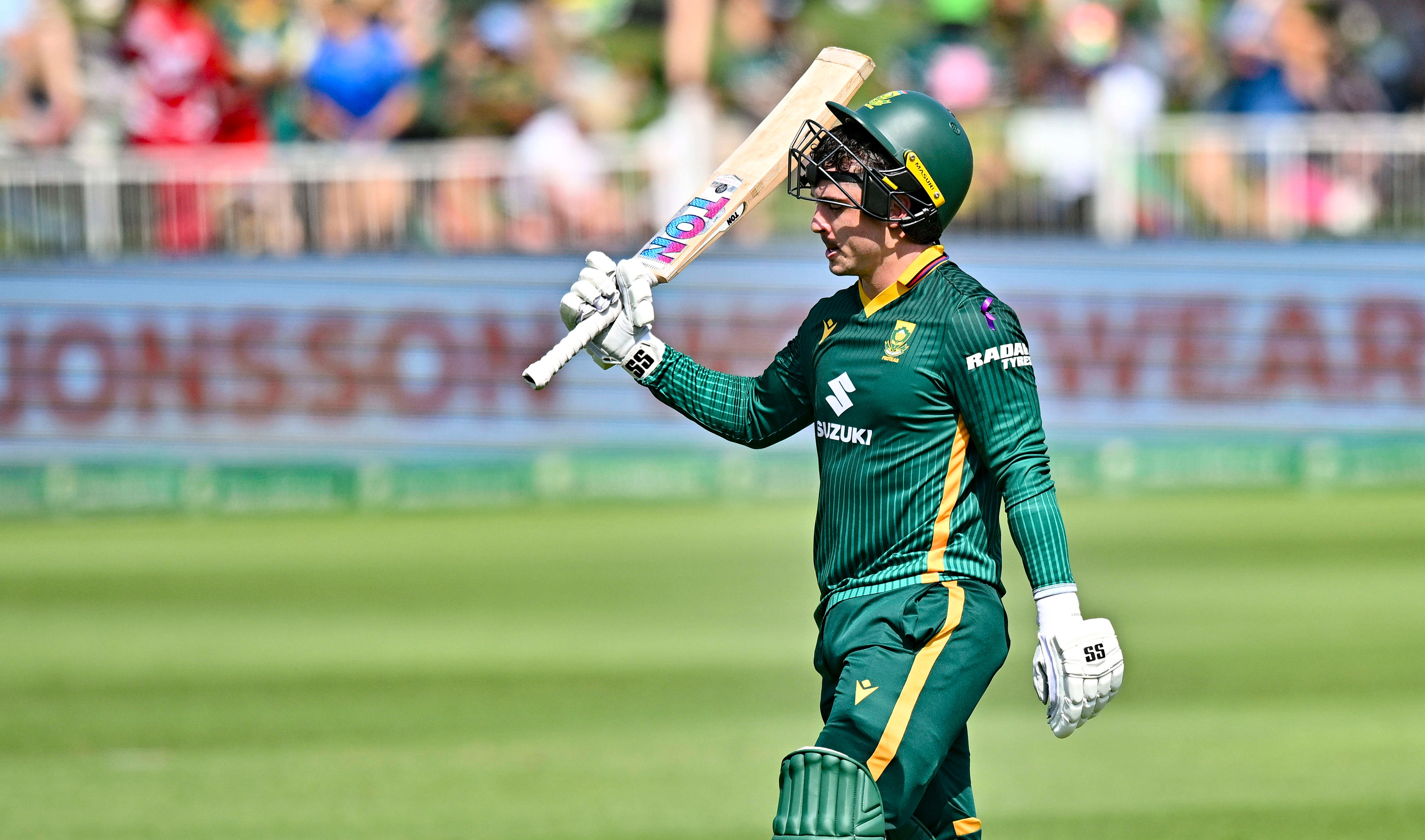 Matthew Breetzke celebrates his century by raising his bat