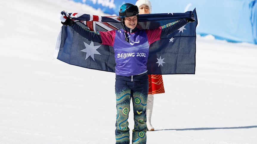 An Australian male Paralympic athlete holds his national flag behind him at the Beijing Games.