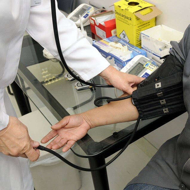 Doctor checks patient's blood pressure.