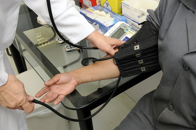 Doctor checks patient's blood pressure.