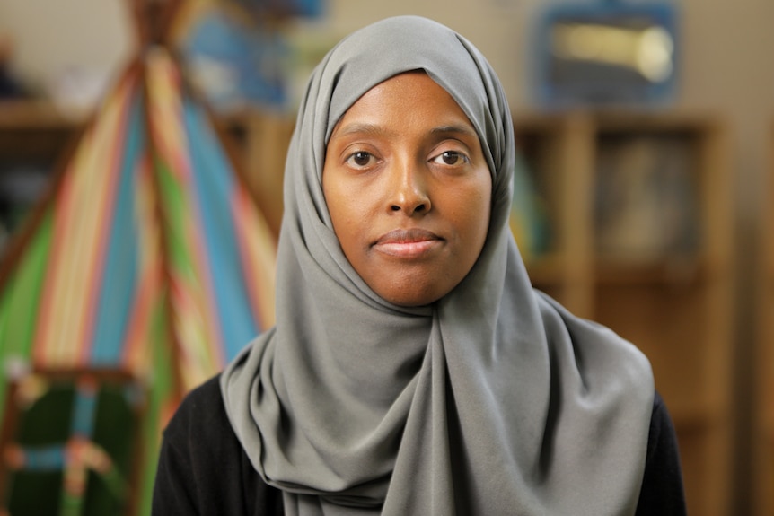 Woman wearing a grey hijab. 