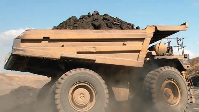 Big mining truck with load of coal