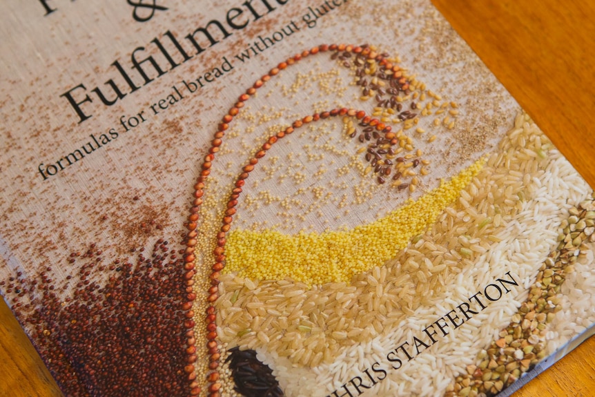 Book cover with lots of bread, rice, quinoa seeds illustrated on it