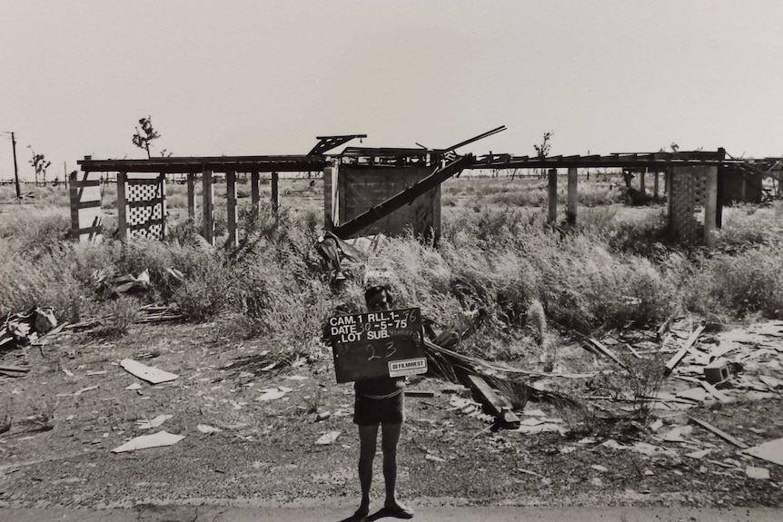 A destroyed house in a black and white photo.