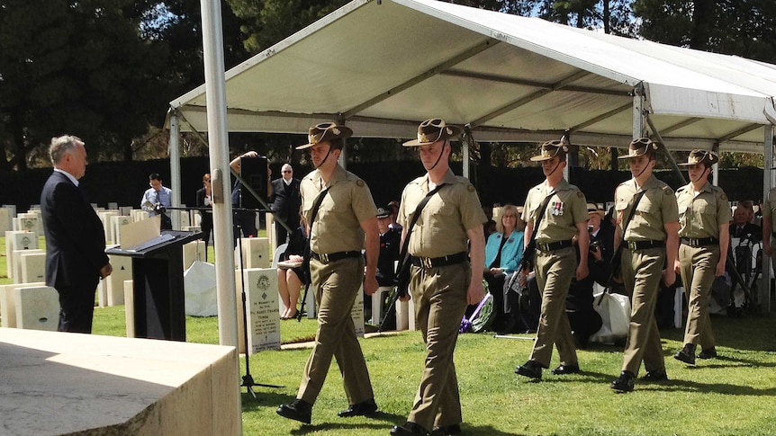 Soldiers take part in a Remembrance Day service in the military burial ground of West Terrace Cemetery in Adelaide.