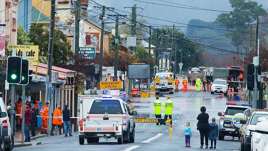 A busy street in Tasmania is flooded over with emergency crews on stand-by.