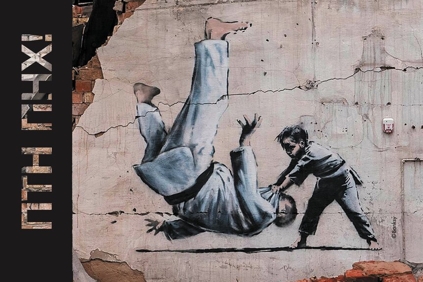 A banksy mural showing vladimir putin being flipped by a child during a judo match. 