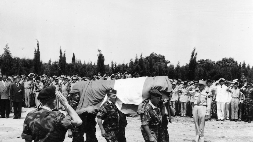 A guard of honour for a fallen legionnaire in Algeria.