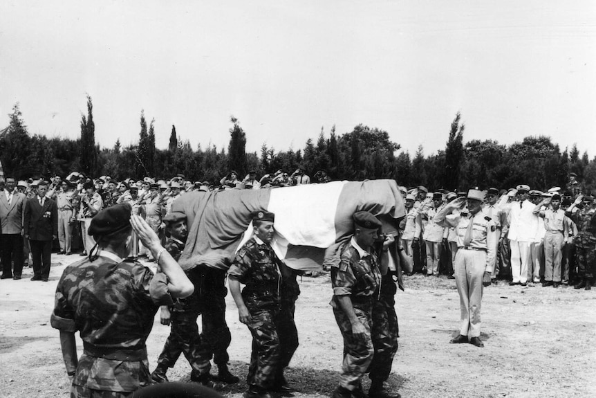 A guard of honour for a fallen legionnaire in Algeria.