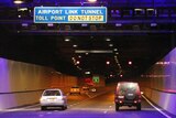 Cars pass under a toll point in the Airport Link tunnel.