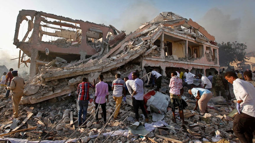 Mogadishu residents search for survivors in a destroyed building.