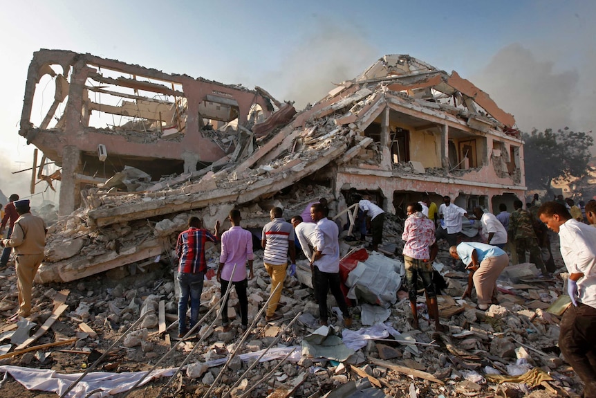 Mogadishu residents search for survivors in a destroyed building.