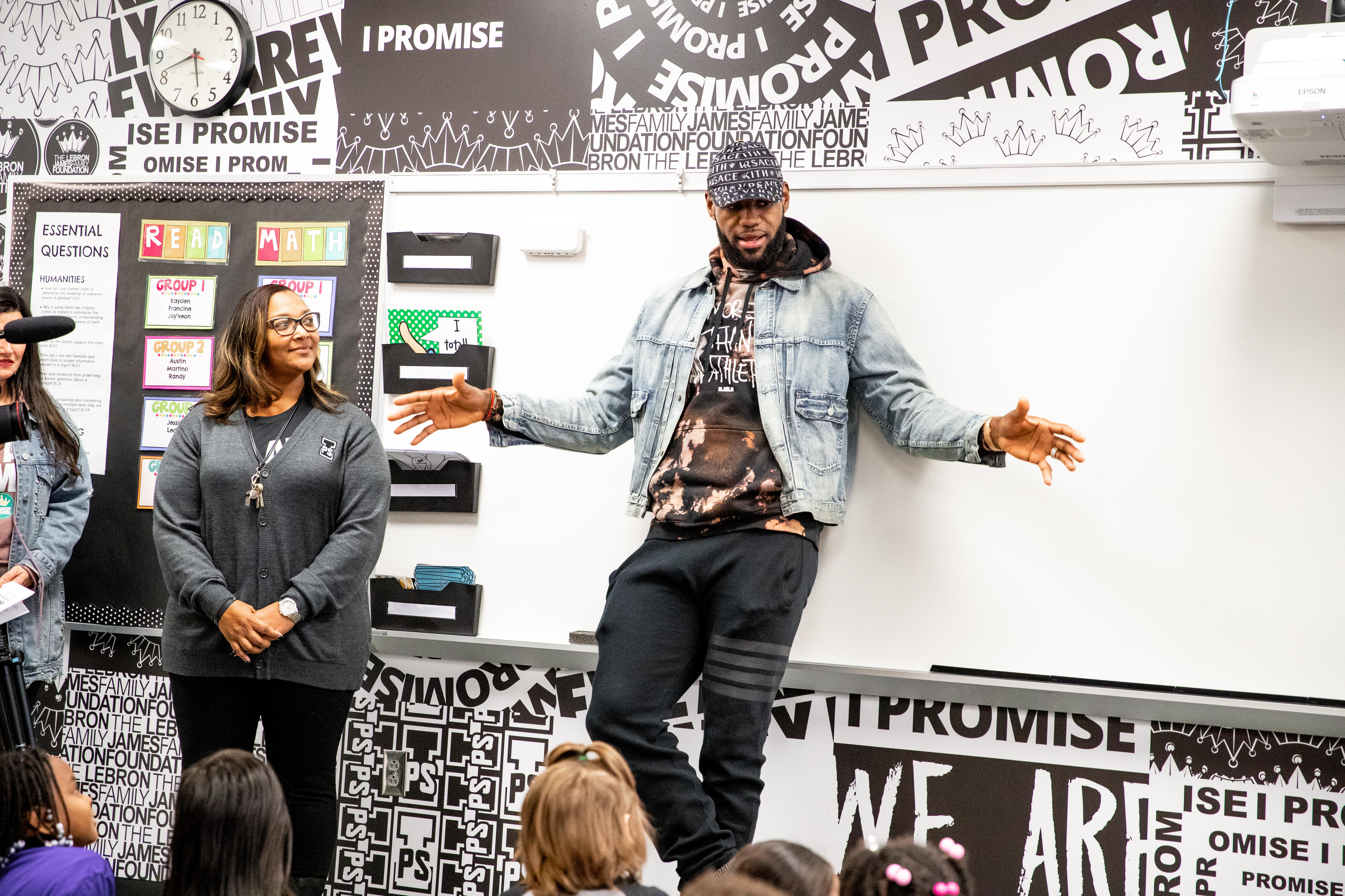 LeBron James stands in front of a white board. 