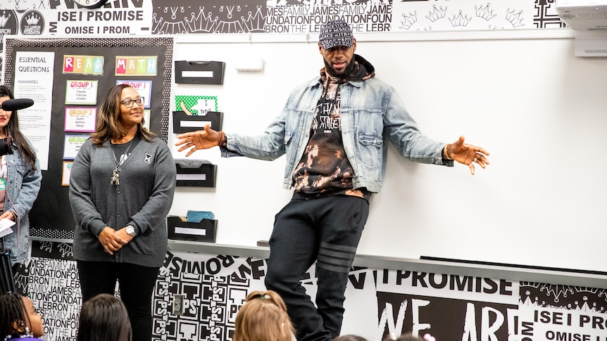 LeBron James stands in front of a white board. 