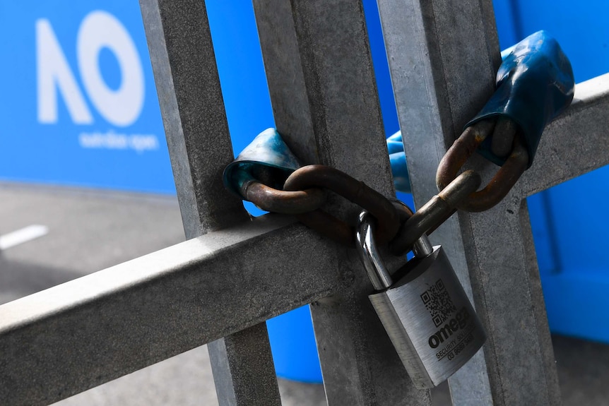 A silver padlock hangs around gates. The Australian Open logo is visible in the background