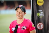 Sydney Sixers cricketer Alyssa Healy stands in front of a microphone during an interview. 