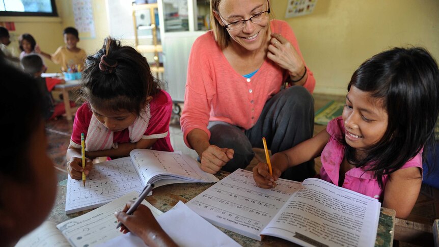 US volunteer teaching English to children in Cambodia