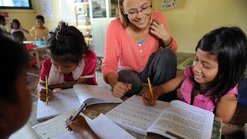 US volunteer teaching English to children in Cambodia