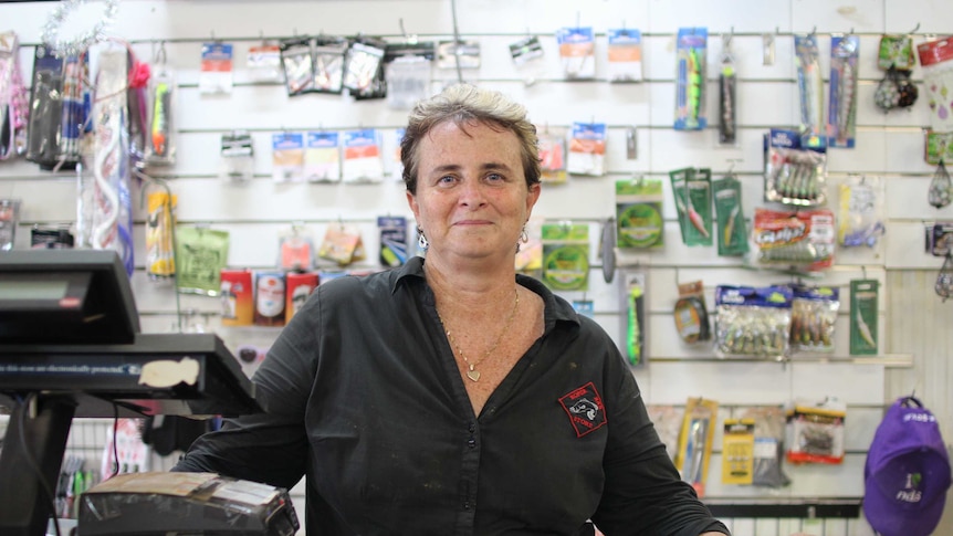 a woman standing behind a store counter