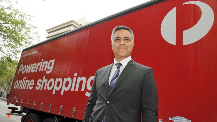 Australia Post chief executive Ahmed Fahour stands in front of an Australia Post truck.