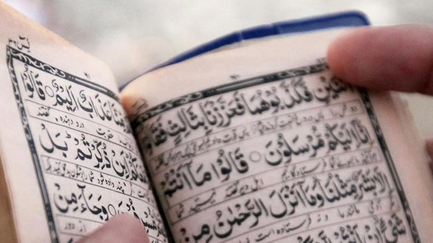 A Muslim pilgrim reads the Koran.