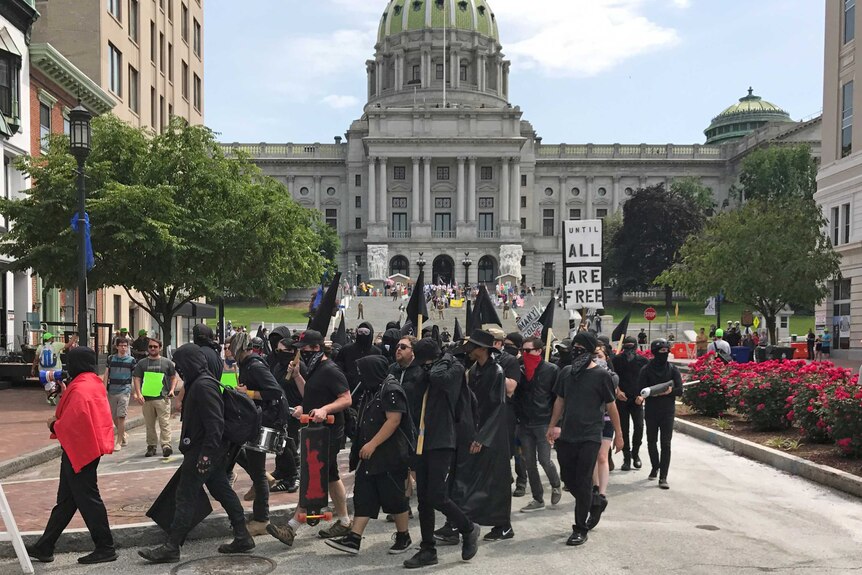 Anti-sharia protesters dressed in black march in front of the State Capitol building in Harrisburg.