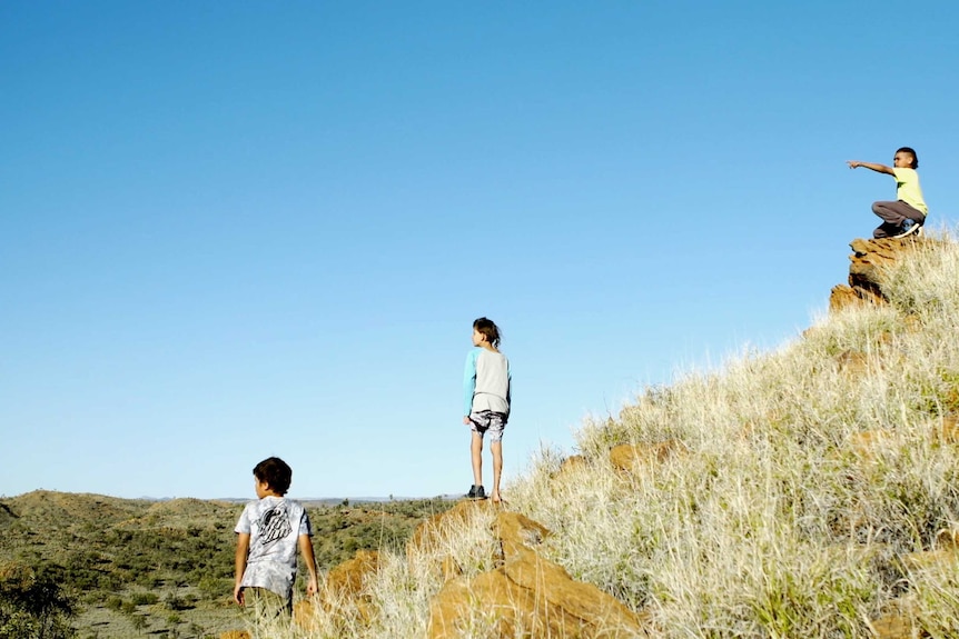 Three Aboriginal children on a rocky outrcrop in the documentary In My Blood It Runs