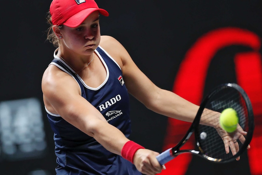 The ball connects with Ash Barty's racket as she plays a backhand in the final of the WTA Finals against Elina Svitolina