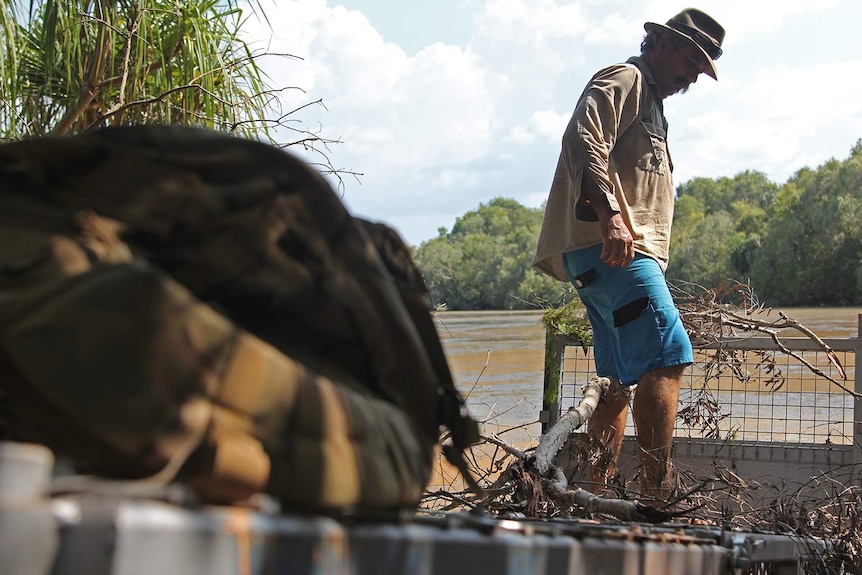 A photo of Roger Matthews standing on top of a crocodile trap.