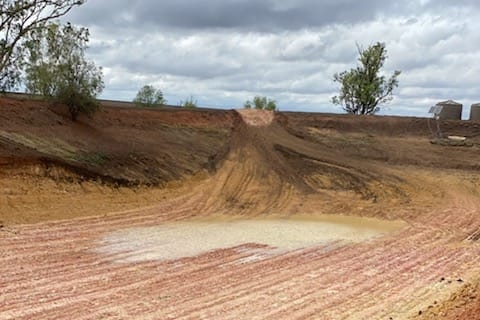 A small puddle and wet soil.