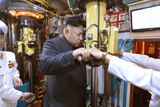 Kim Jong-un looks through periscope