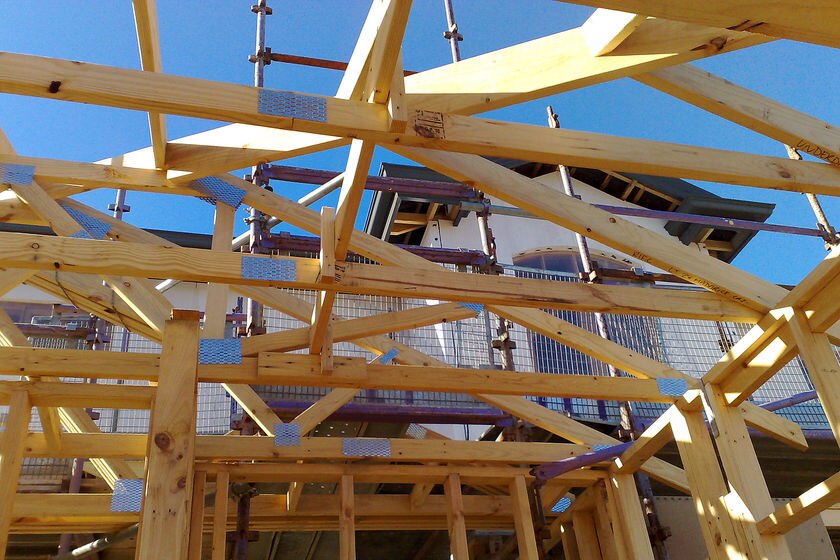 The timber frame of a house under construction.