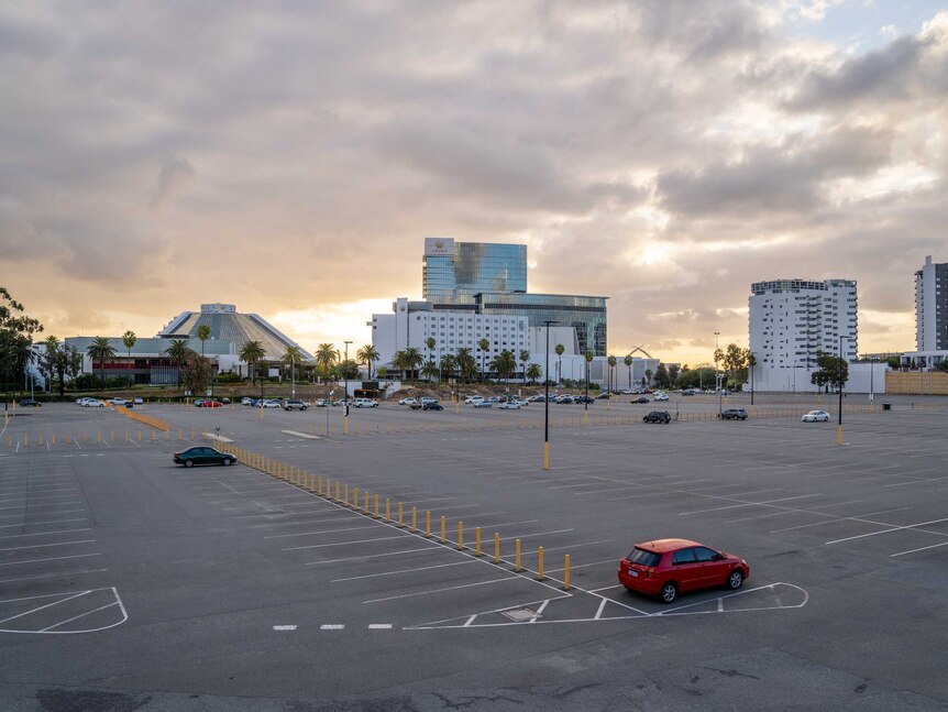 An almost empty car park at the casino, including one red car at the end of the aisle