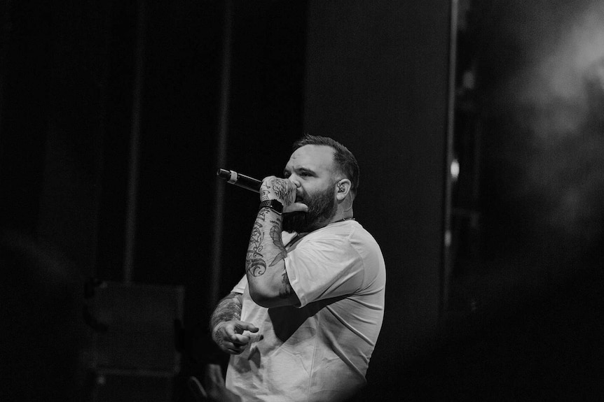 Colour photo of rapper Briggs performing on stage at Sydney Opera House.