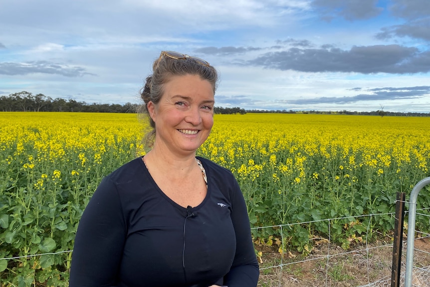 woman smiling in canola field