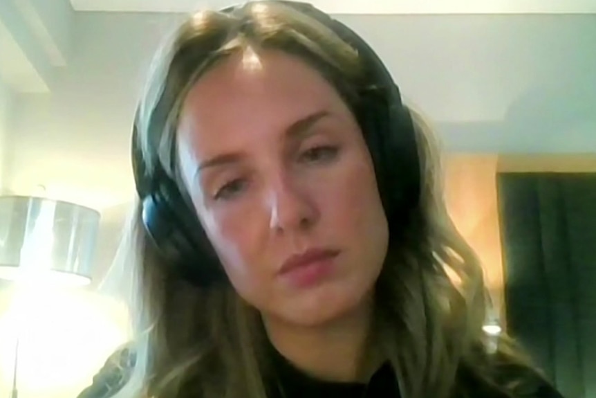 A woman wearing headphones on a Skype call.