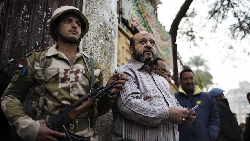 Voters gather outside a polling station in Cairo, December 15, 2012.