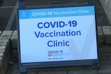 A sign on a computer screen saying COVID–19 vaccination clinic