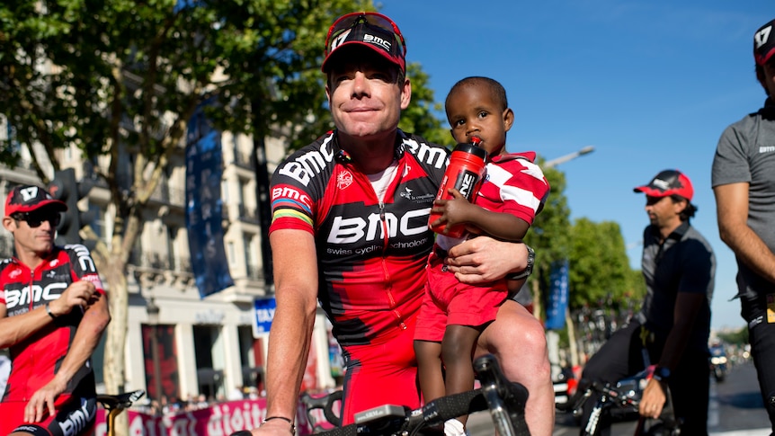 Post-race duties: Evans takes son Robel for a ride after the end of the Tour.