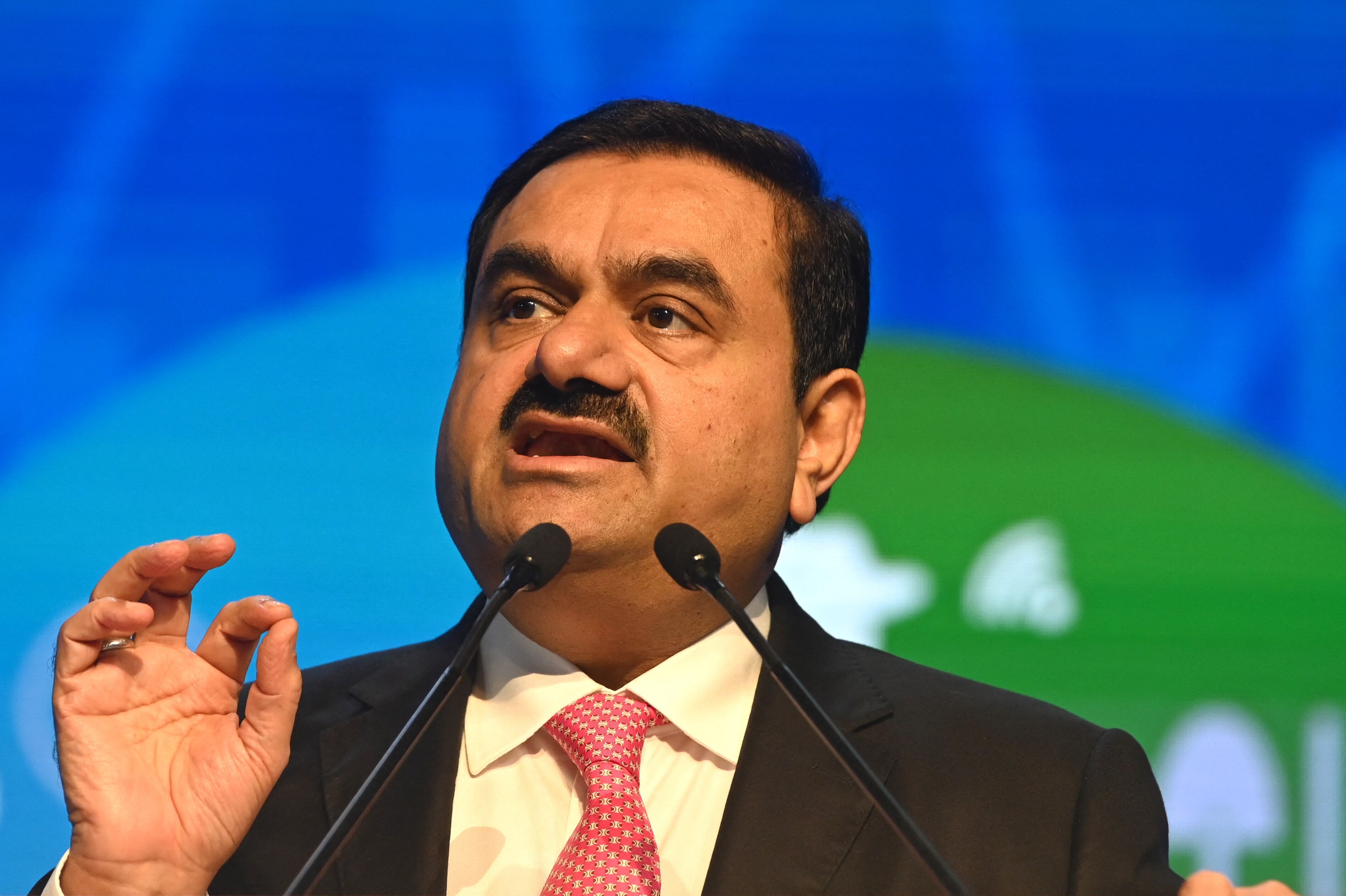 Gautam Adani speaks at a lectern