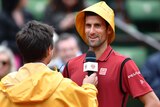 Novak Djokovic in a rain hat at the French Open