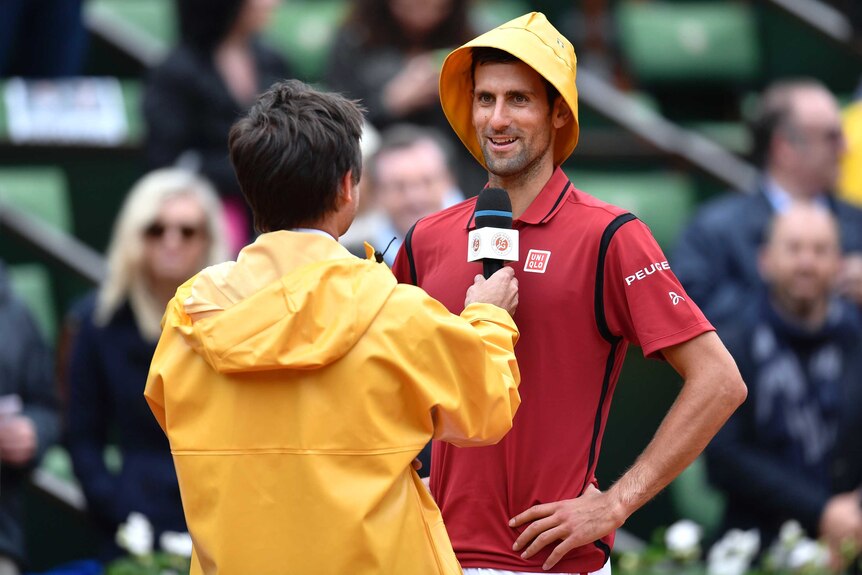 Novak Djokovic in a rain hat at the French Open