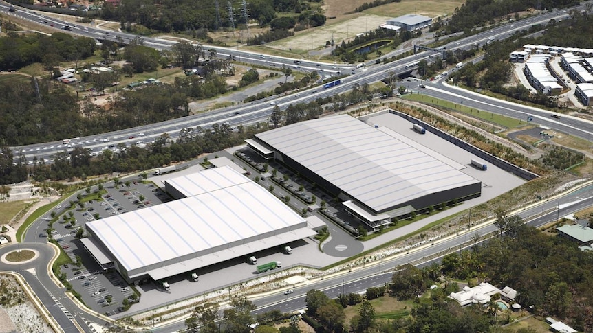 An aerial shot of two large warehouses alongside main roads.