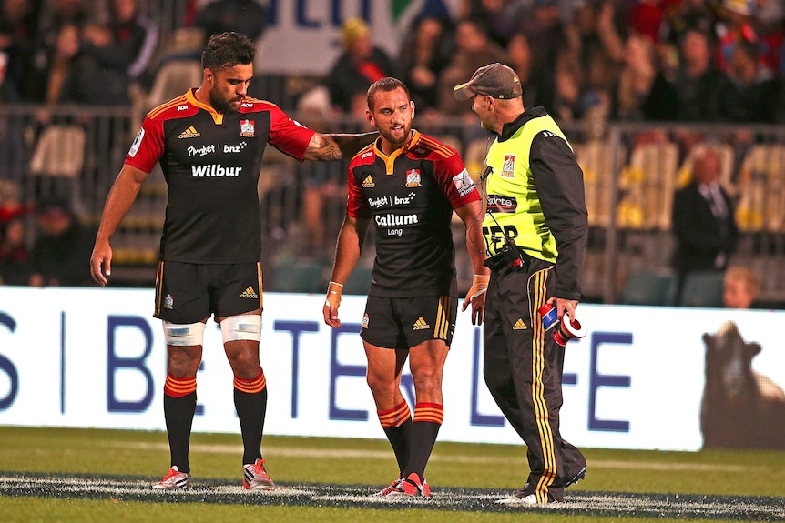 Aaron Cruden is helped off the field with a knee injury