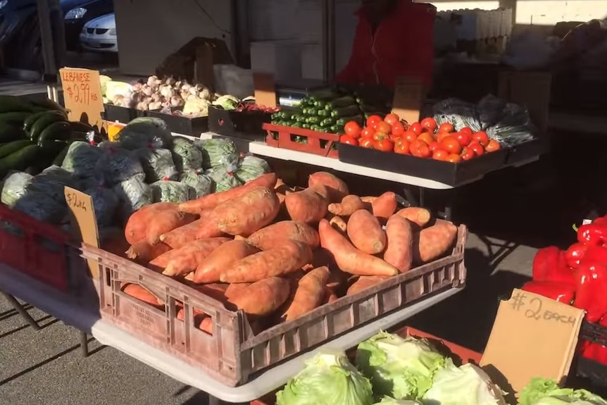 Fresh produce on trestle tables at the market