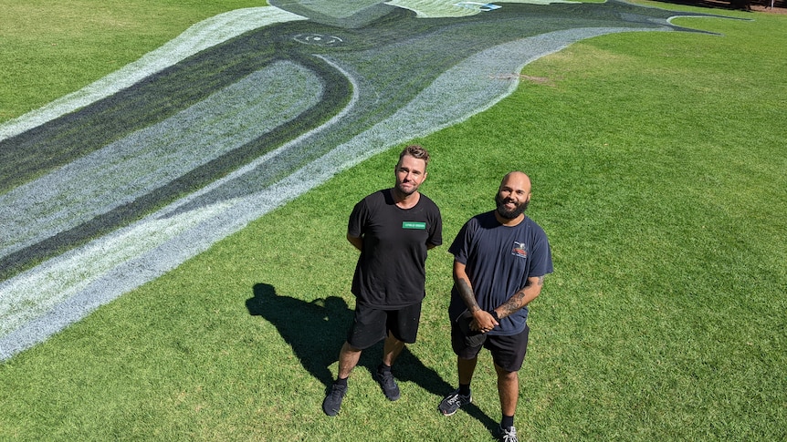 Jacob and Tyrown pictured from above with the whale design behind them.