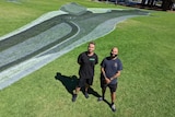 Jacob and Tyrown pictured from above with the whale design behind them.